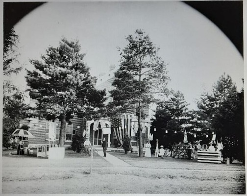 July 4, 1898. The Conger House was decorated for a fete to raise money for soldiers of Company D, 30th Inf., going to fight in the Spanish American war. The man on the sidewalk, center, is Col. C. J. Wilson.