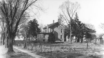 South side of the house. The privy may be seen in the far right corner.